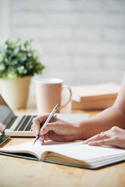 unrecognizable-woman-sitting-desk-indoors-writing-planner (1) (1) unrecognizable-woman-sitting-desk-indoors-writing-planner (1) (1)